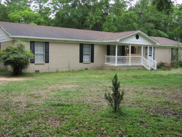 1112 Country Living Road Baker, FL 32531 - Photo 2 of 16 a front view of a house with a yard and porch