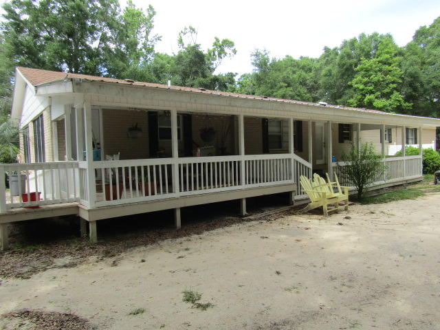 1112 Country Living Road Baker, FL 32531 - Photo 14 of 16 a view of a house with a yard and deck