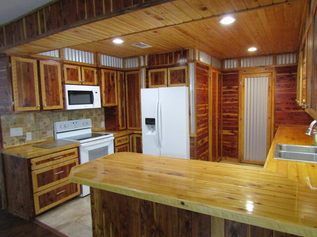 1112 Country Living Road Baker, FL 32531 - Photo 5 of 16 a view of kitchen with stainless steel appliances kitchen island granite countertop a stove and a refrigerator