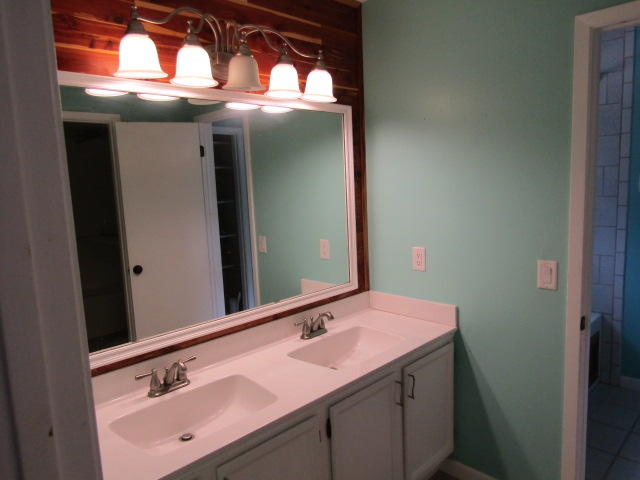 1112 Country Living Road Baker, FL 32531 - Photo 8 of 16 a bathroom with a sink and a mirror
