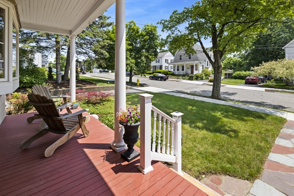 29 Boulevard Road Dedham, MA 02026 - Photo 2 of 34 a view of a patio with couches table and chairs and wooden floor