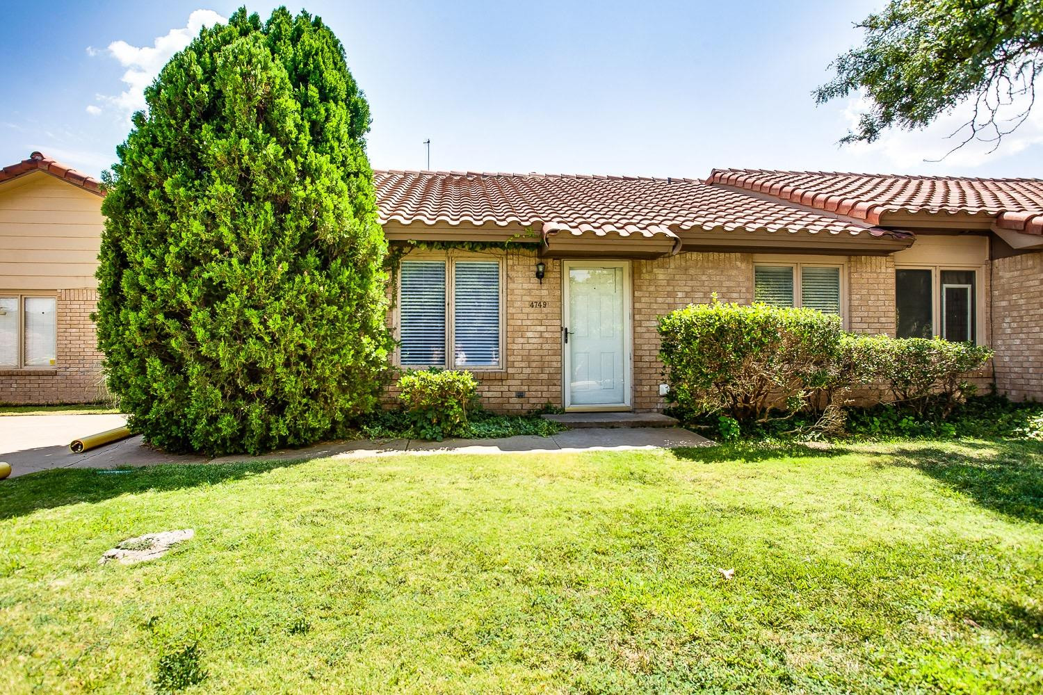 a view of a house with a yard and plants