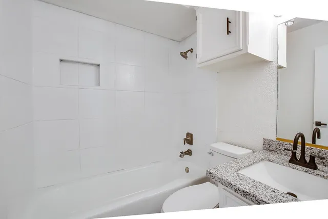 a bathroom with a bathtub and a sink