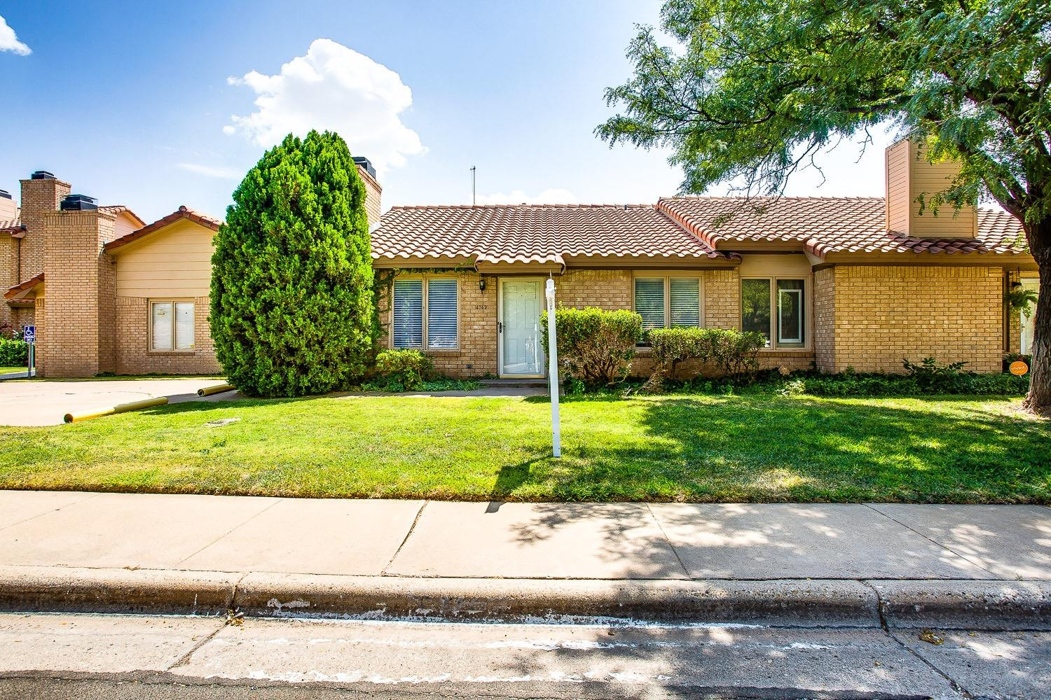 4749 2nd Street Lubbock, TX 79416 - Photo 2 of 13 a view of a house with a yard and a large tree center