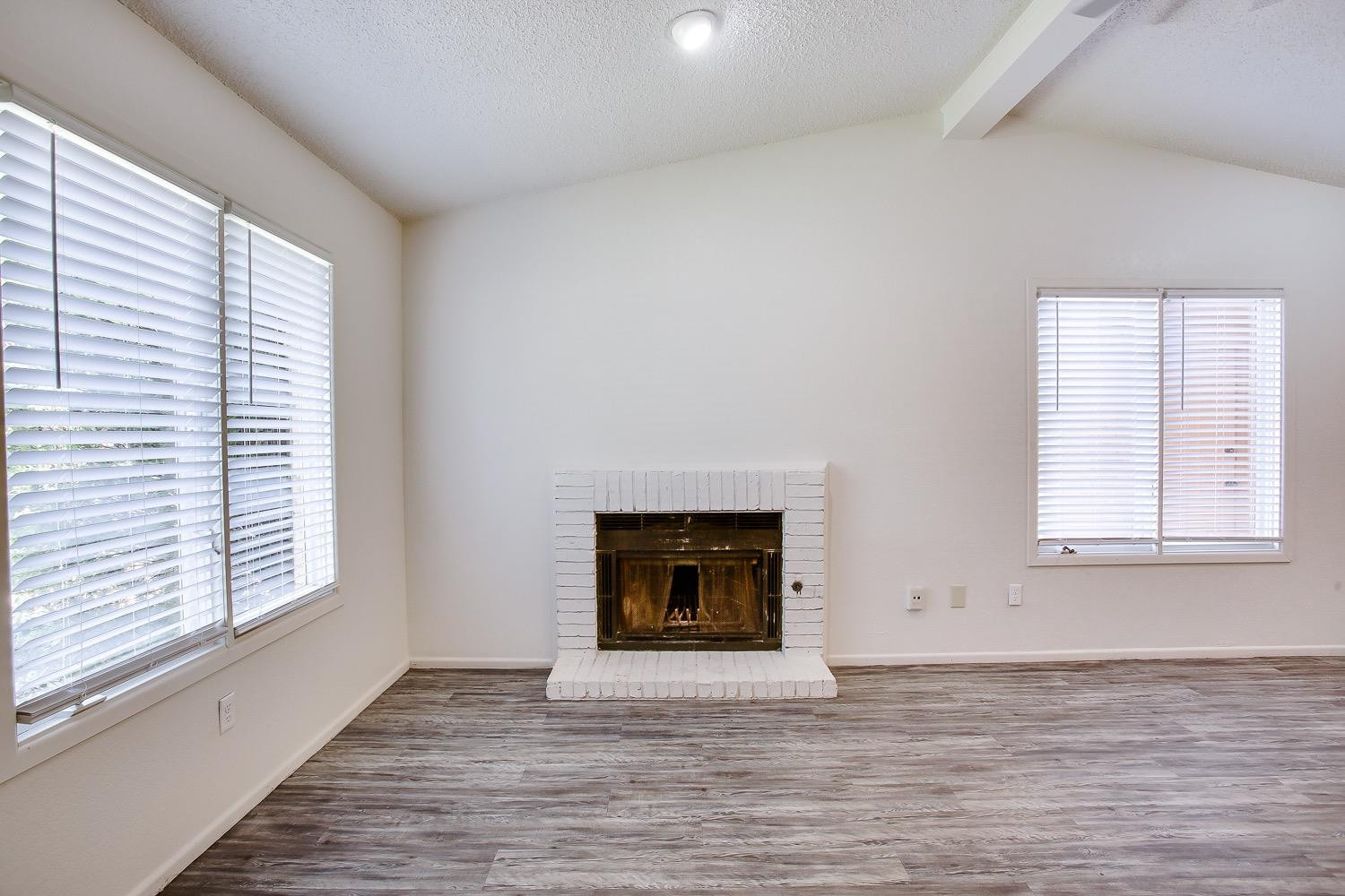 4749 2nd Street Lubbock, TX 79416 - Photo 3 of 13 an empty room with windows and fireplace