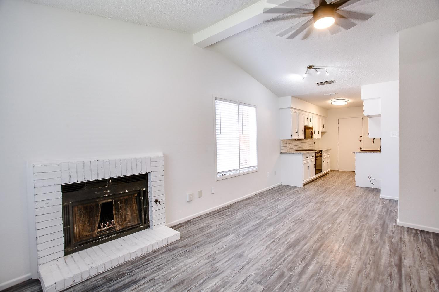 4749 2nd Street Lubbock, TX 79416 - Photo 5 of 13 a view of kitchen with livingroom and fireplace