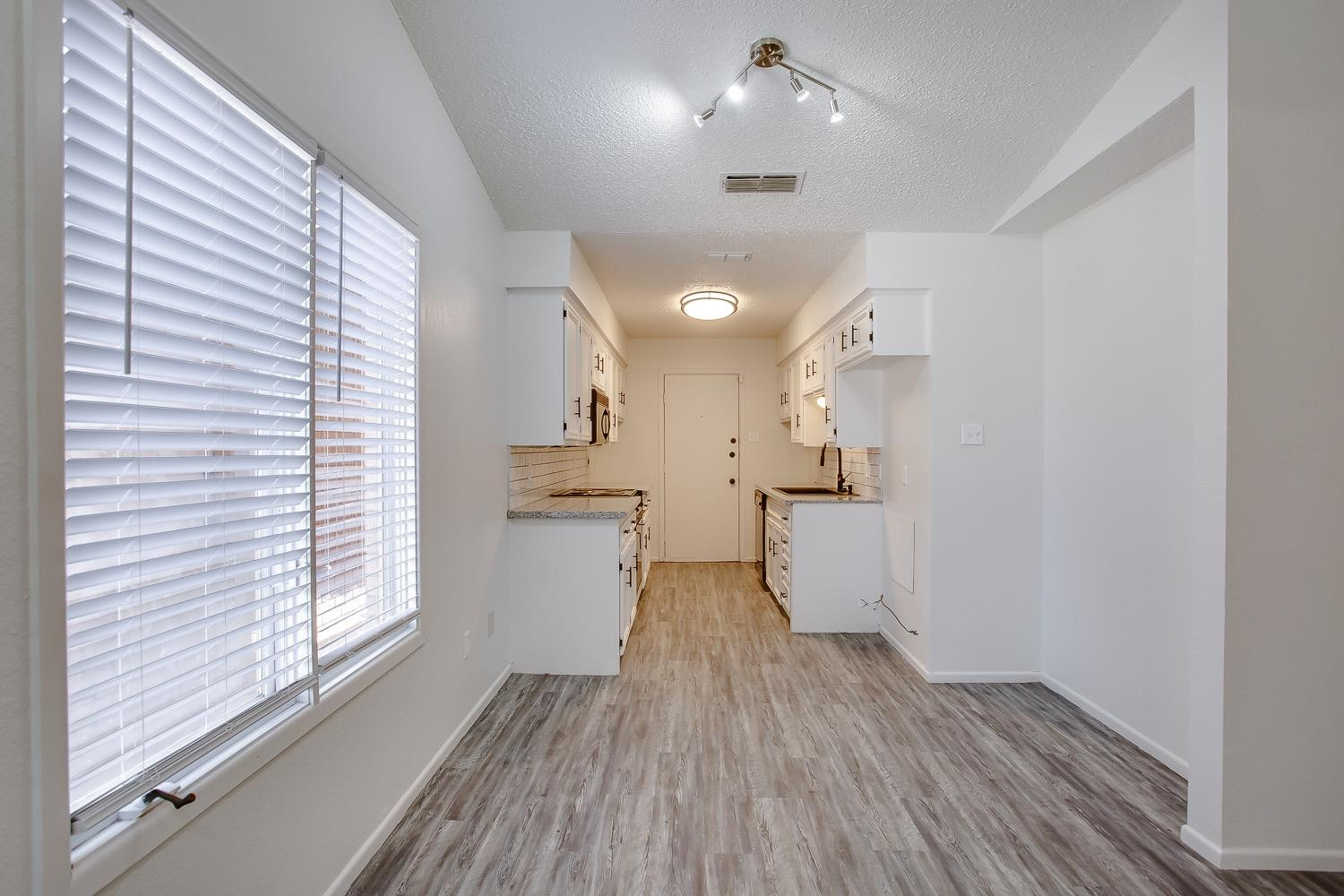 4749 2nd Street Lubbock, TX 79416 - Photo 6 of 13 a view of a kitchen with wooden floor and a window