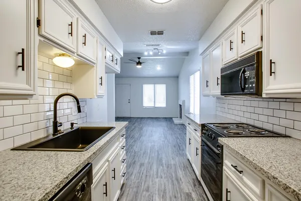 a kitchen that has a sink and a stove