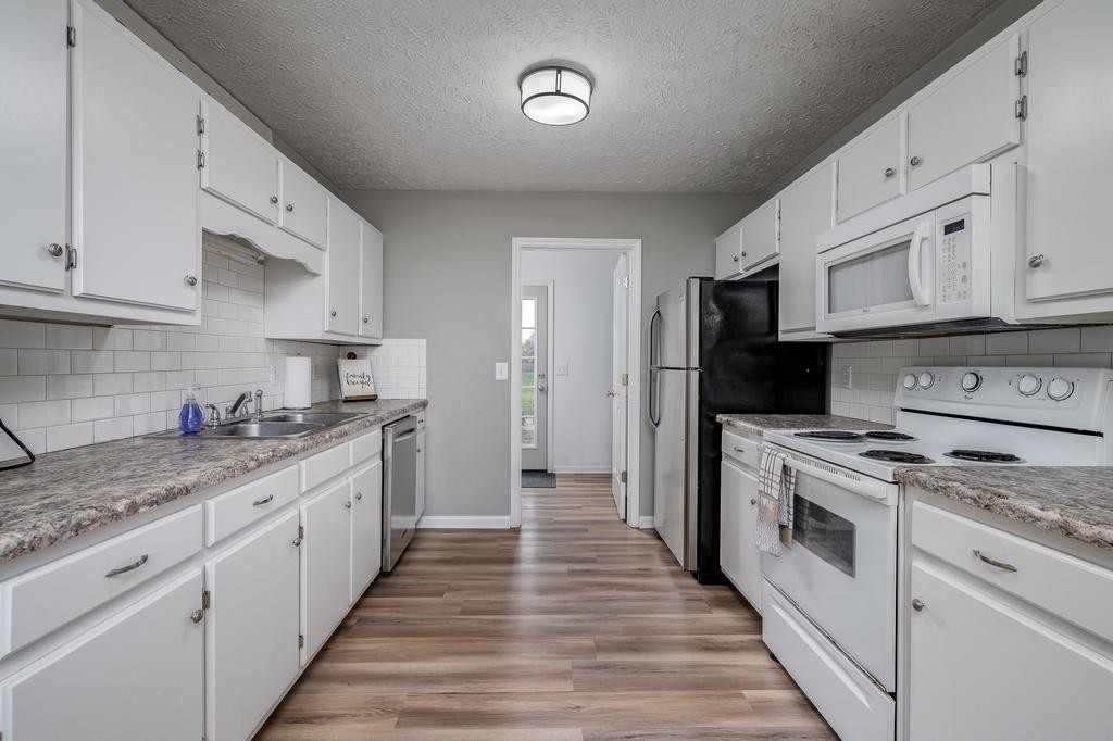 636 Crescent Road Murfreesboro, TN 37128 - Photo 5 of 22 a kitchen with granite countertop white cabinets and stainless steel appliances