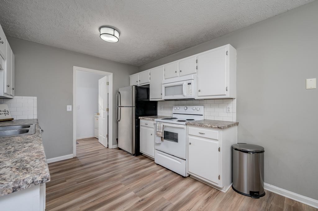 636 Crescent Road Murfreesboro, TN 37128 - Photo 7 of 22 a kitchen with stainless steel appliances white cabinets and a refrigerator