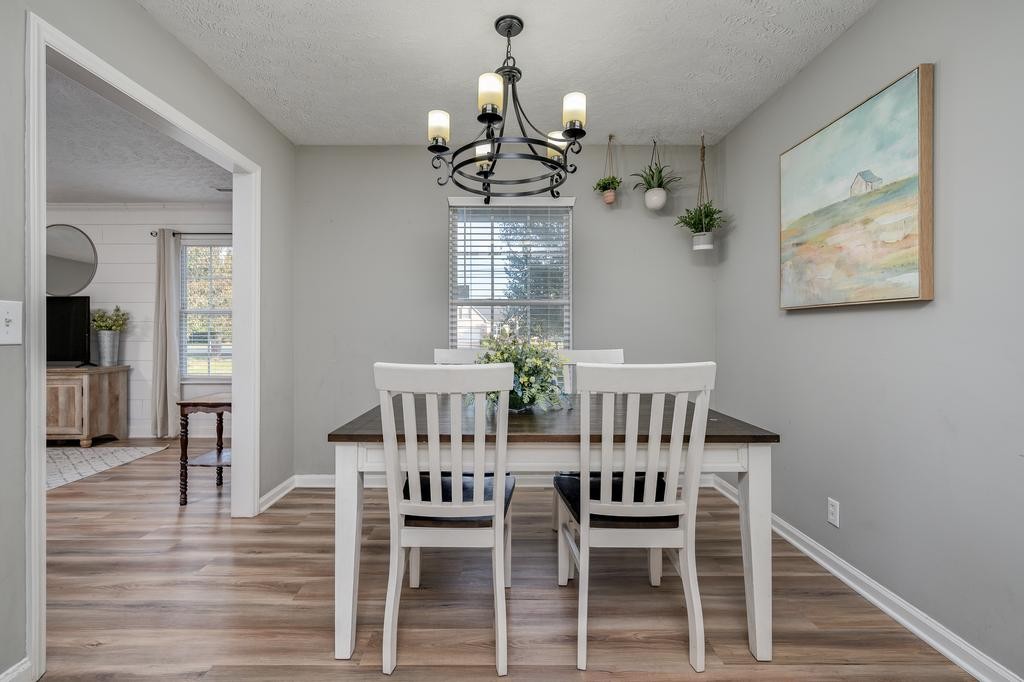 636 Crescent Road Murfreesboro, TN 37128 - Photo 8 of 22 a view of a dining room with furniture wooden floor and chandelier