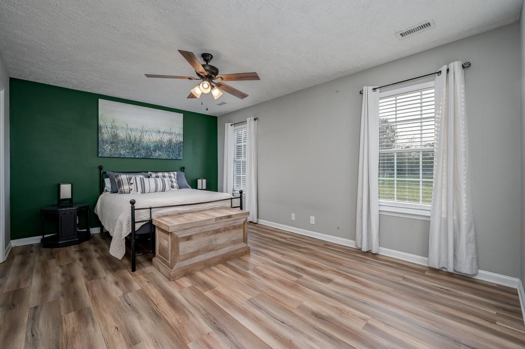 636 Crescent Road Murfreesboro, TN 37128 - Photo 10 of 22 a bedroom with a bed and a chandelier