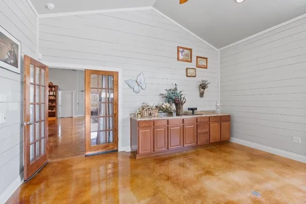 a view of a hallway to a livingroom with furniture