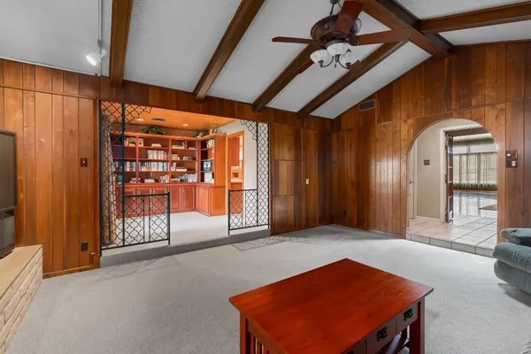 a kitchen with stainless steel appliances kitchen island granite countertop a table chairs sink and cabinets