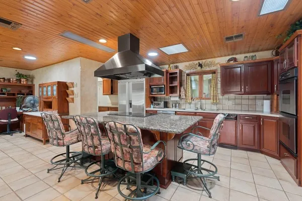 a kitchen with stainless steel appliances granite countertop a sink and cabinets