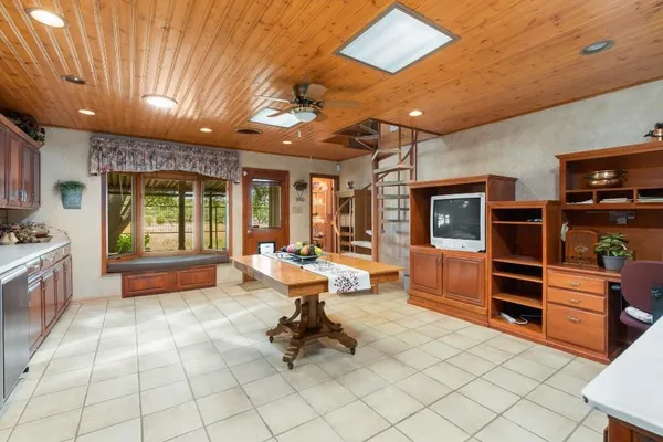 a bathroom with a granite countertop sink mirror and toilet