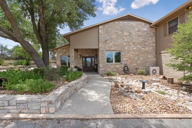 a view of a house with backyard and sitting area