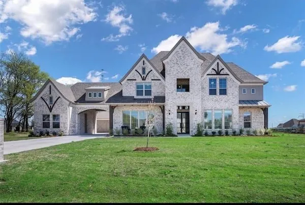 a front view of house with yard and green space