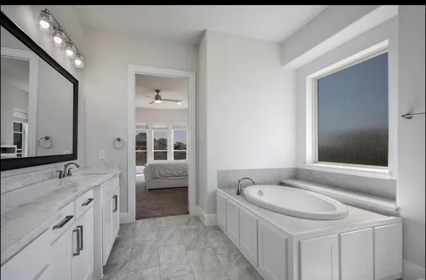 a bathroom with a double vanity sink and a mirror