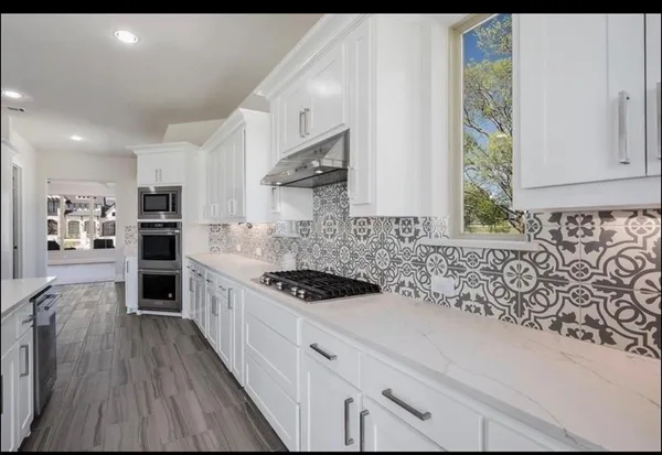 a kitchen with sink and cabinets