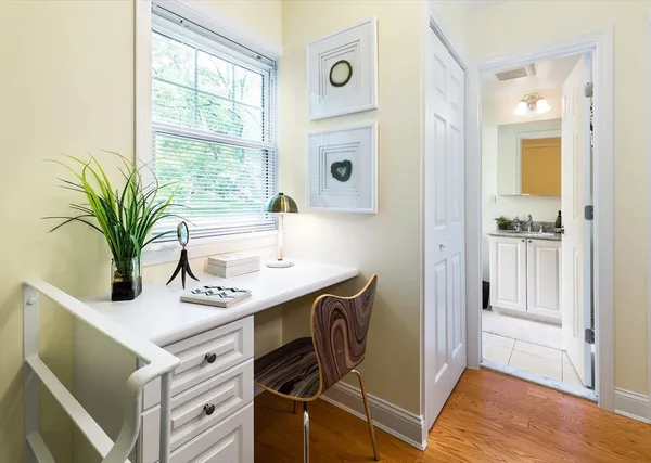 a bath room with a sink and a window