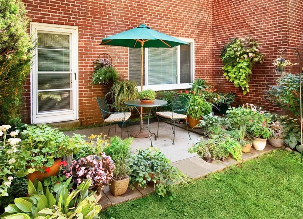 97 Gerry Road, Unit 97 Brookline, MA 02467 - Photo 6 of 6 a front view of a house with a yard and fountain