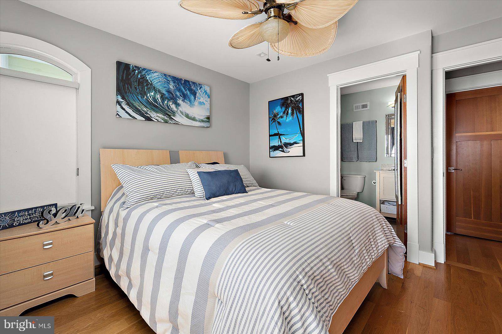 12957 Harbor Road Ocean City, MD 21842 - Photo 103 of 148 a bedroom with bed and a chandelier