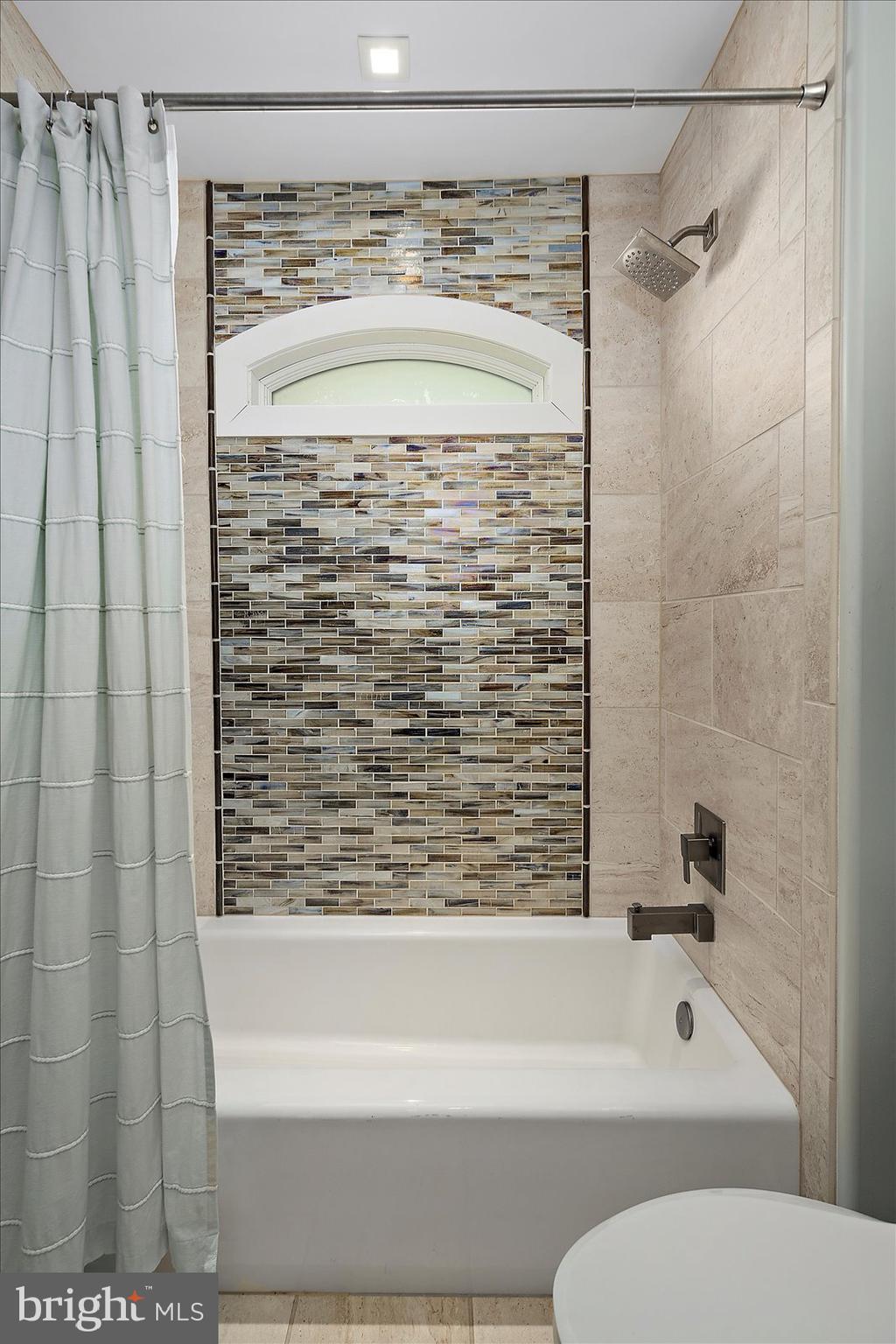 12957 Harbor Road Ocean City, MD 21842 - Photo 105 of 148 a bathroom with a shower and a bath tub