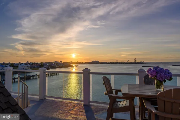 a bathroom with a granite countertop sink and a window