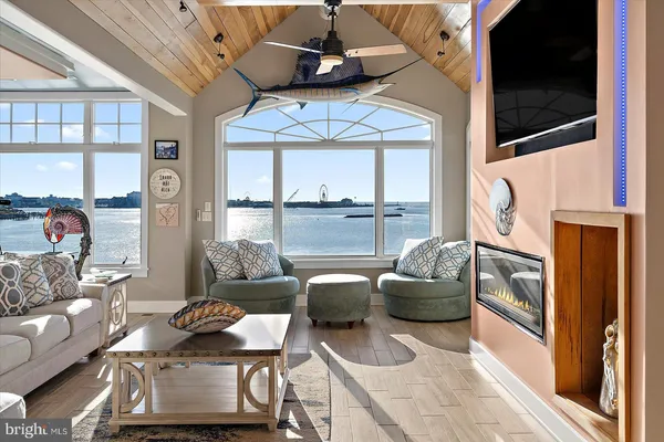 a view of a dining room with furniture large windows and wooden floor