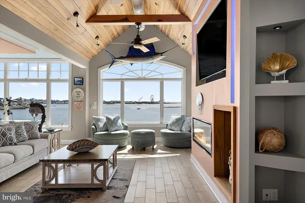 a room with furniture and view of pool