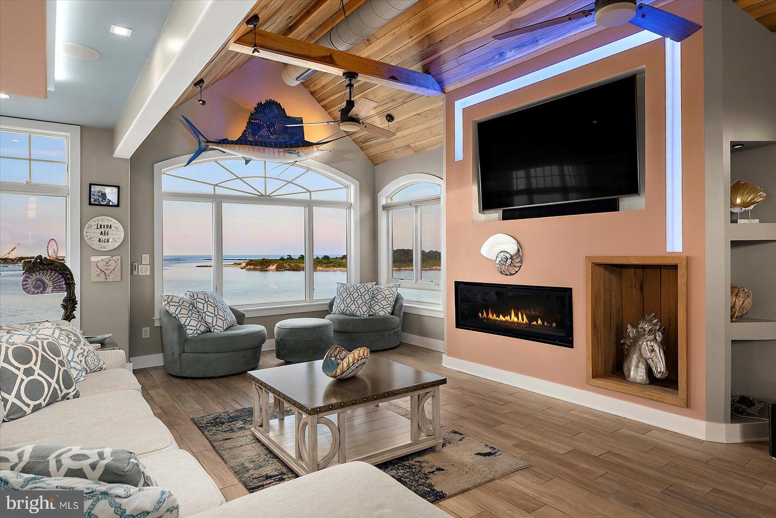 12957 Harbor Road Ocean City, MD 21842 - Photo 31 of 148 a living room with furniture a flat screen tv and a fireplace