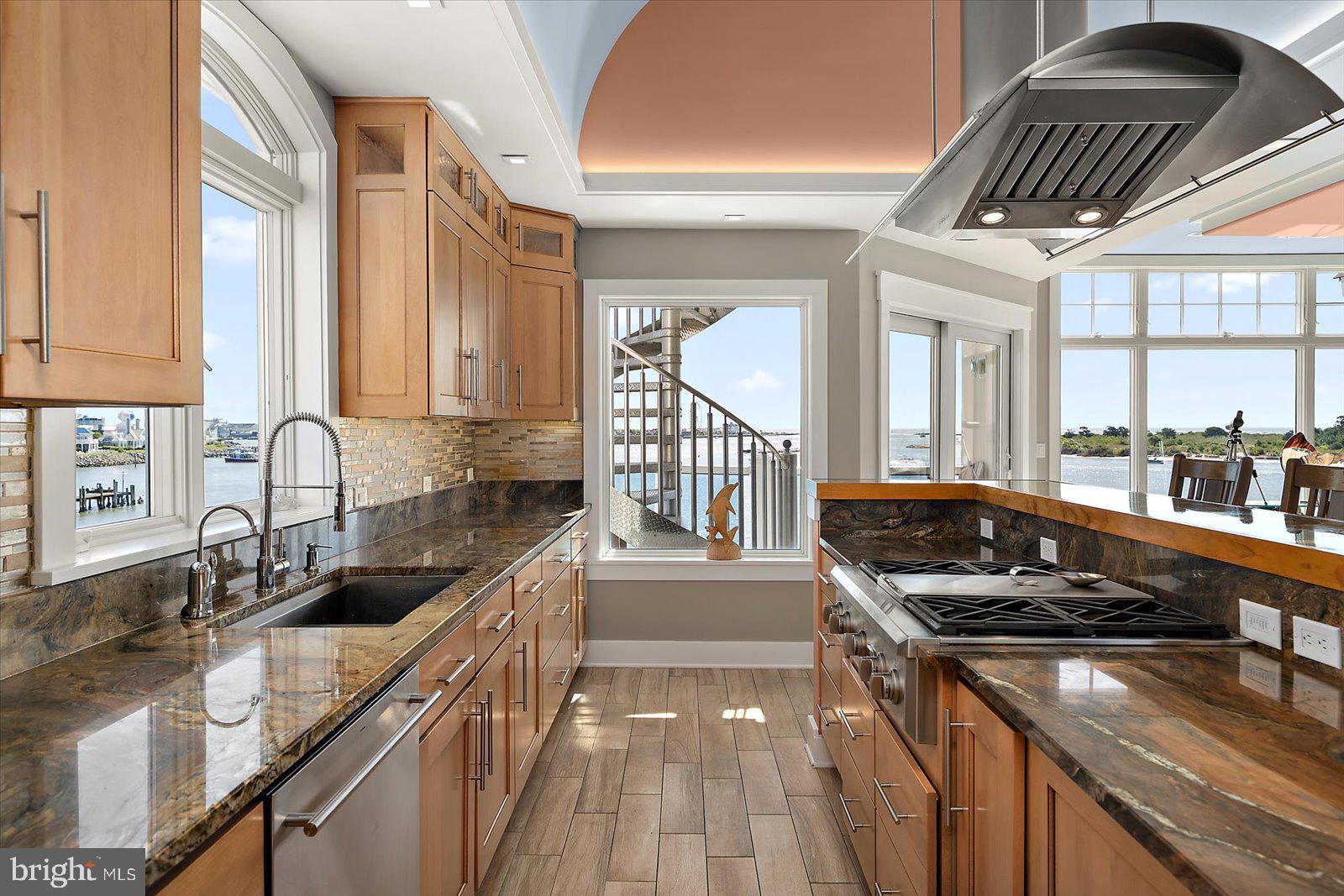 12957 Harbor Road Ocean City, MD 21842 - Photo 46 of 148 a kitchen with granite countertop a stove a sink and a granite counter tops