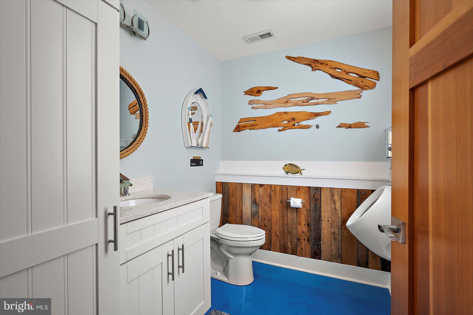 12957 Harbor Road Ocean City, MD 21842 - Photo 76 of 148 a bathroom with a toilet a sink and mirror