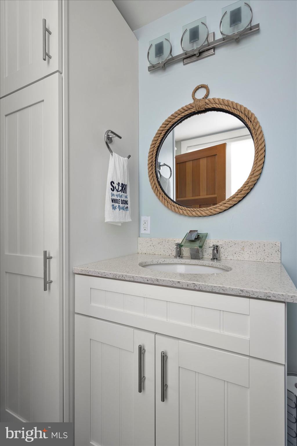 12957 Harbor Road Ocean City, MD 21842 - Photo 77 of 148 a bathroom with a sink and mirror
