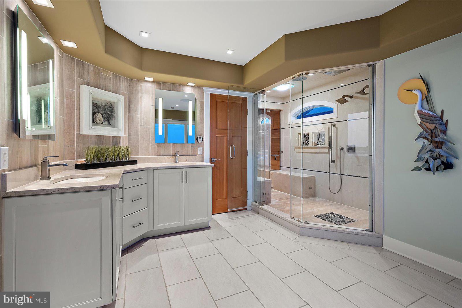 12957 Harbor Road Ocean City, MD 21842 - Photo 90 of 148 a large bathroom with a glass door shower and sink