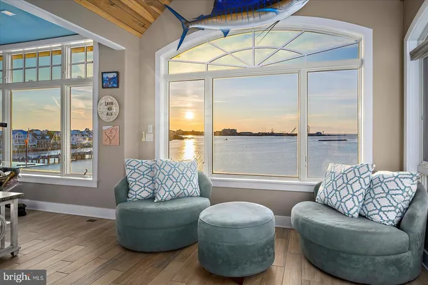 a view of livingroom with furniture wooden floor a rug and a fireplace
