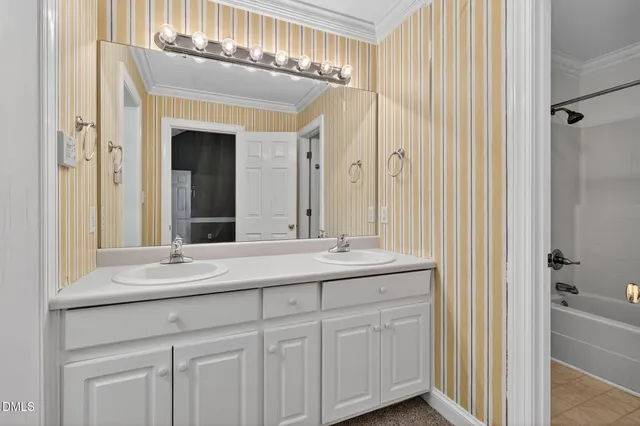 a bathroom with a double vanity sink and a mirror