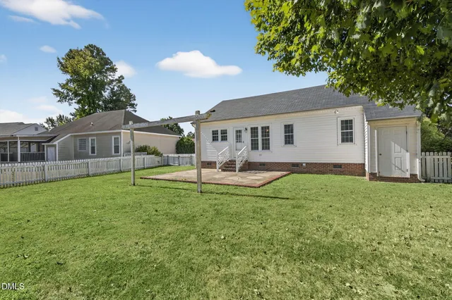 a view of a house with a backyard and a patio