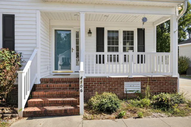 front view of a house with wooden stairs and windows