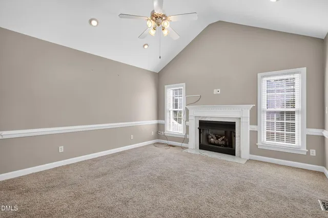 a view of empty room with a fireplace