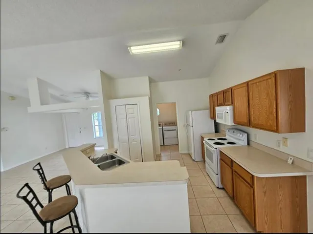a kitchen with a stove top oven and a refrigerator