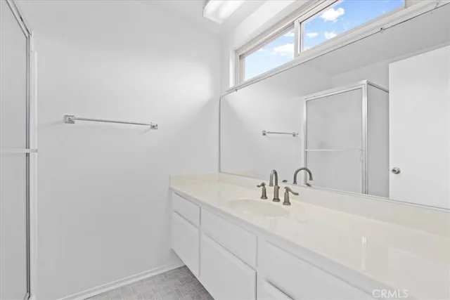 a backyard of a house with plants and palm trees