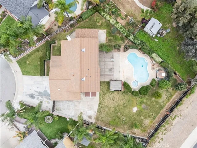 an aerial view of residential houses with outdoor space and parking