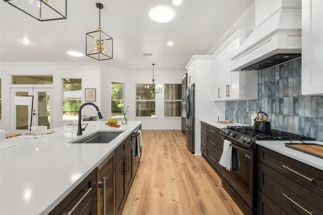 a kitchen with stainless steel appliances granite countertop a sink and stove