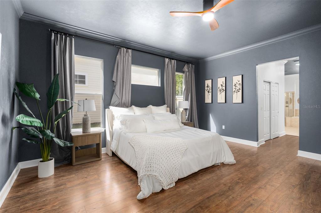 6326 Southwest 90th Street Gainesville, FL 32608 - Photo 17 of 44 a bedroom with a large bed and a potted plant