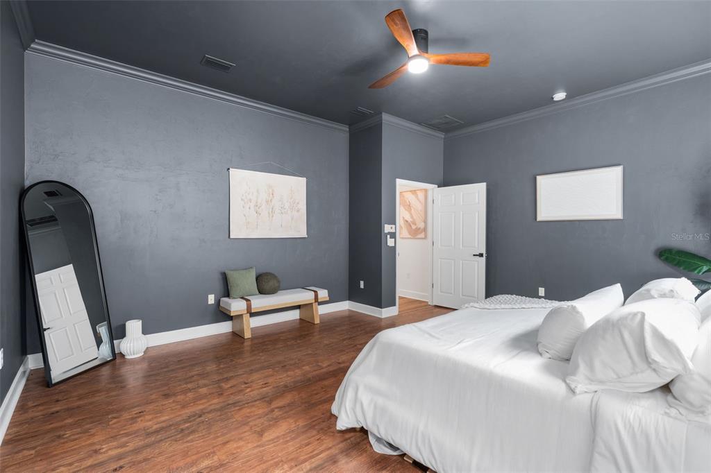 6326 Southwest 90th Street Gainesville, FL 32608 - Photo 18 of 44 a bedroom with a bed and wooden floor