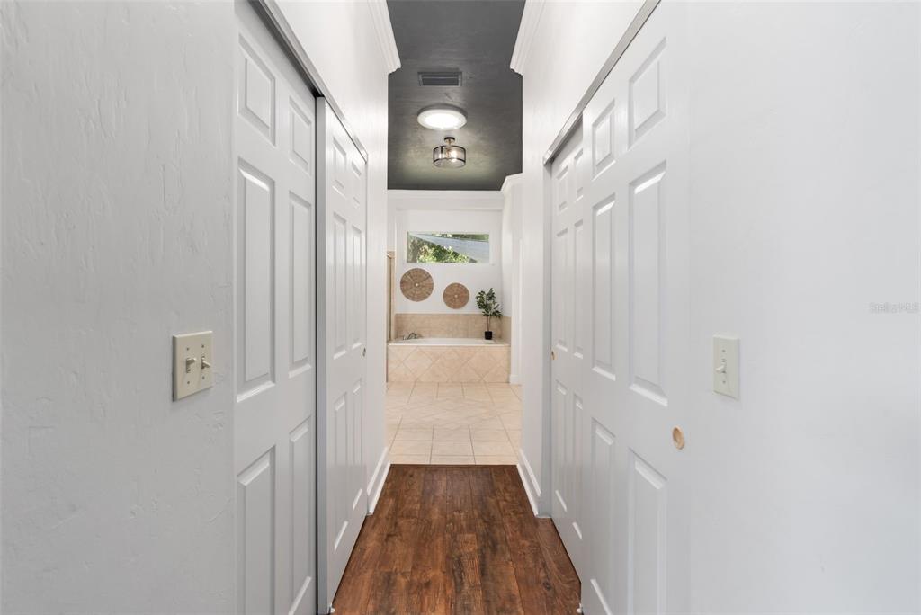 6326 Southwest 90th Street Gainesville, FL 32608 - Photo 19 of 44 a view of a hallway with wooden floor and staircase