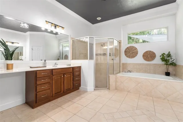 a spacious bathroom with a granite countertop sink a mirror a vanity and a bathtub