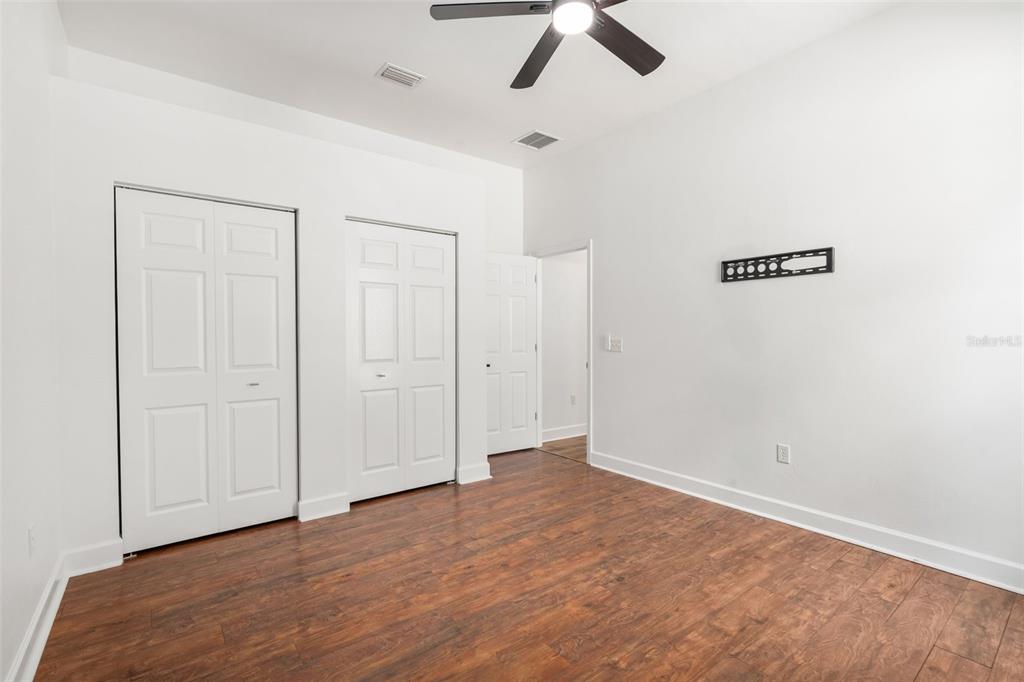 6326 Southwest 90th Street Gainesville, FL 32608 - Photo 27 of 44 an empty room with ceiling fan and window